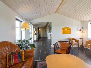 a living room with a couch and a table at Holiday Home Fabio - 450m from the sea in NW Jutland by Interhome in Løkken