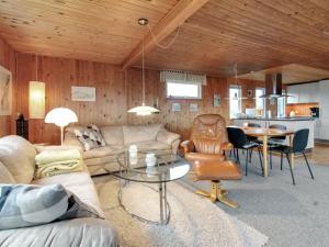 a living room with a couch and a table at Holiday Home Thurid - 200m from the sea in NW Jutland by Interhome in Løkken