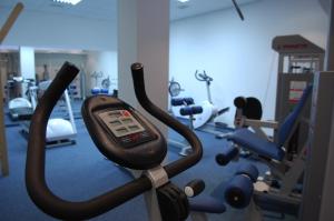 a gym with a cell phone on a exercise bike at Apartments Marija in Postira