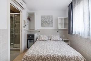a bedroom with a large bed and a shower at Hostal House in Barcelona