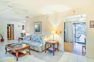 a living room with a couch and a table at Waterfront Port St Lucie Home with Lanai and Pool in Walton