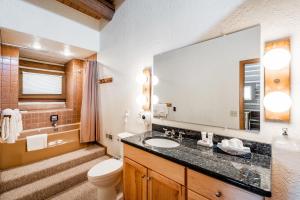 a bathroom with a sink and a toilet and a mirror at Temptation 8 condo in Park City