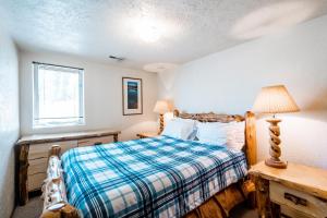 a bedroom with a bed and a table and a window at Temptation 8 condo in Park City +9 photos