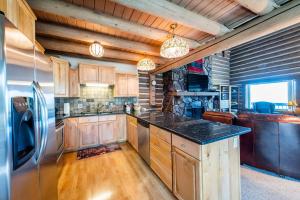 a kitchen with wooden cabinets and a stainless steel refrigerator at Temptation 8 condo in Park City