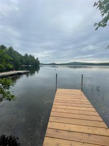 a wooden dock on a body of water at MAINE PINES LMIT 8 home in Denmark