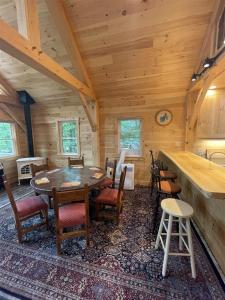 a dining room with a table and chairs in a cabin at MAINE PINES LMIT 8 home in Denmark