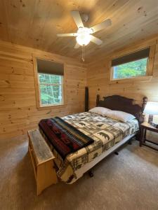 a bedroom with a bed and a ceiling fan at MAINE PINES LMIT 8 home in Denmark