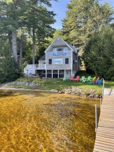 a house on the shore of a body of water at TREMONT LIMIT 10 villa in Bridgton