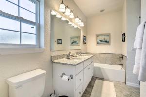 a bathroom with a toilet and a sink and a mirror at Canal-Front Home with Boat Dock in Crystal River in Crystal River +25 photos