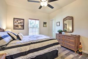 a bedroom with a bed and a dresser and a mirror at Canalside Crystal River Home with Dock and Kayaks in Crystal River