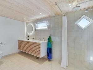 a bathroom with a sink and a mirror at Holiday Home Henric - 100m from the sea by Interhome in Blokhus