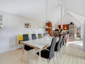 a kitchen and dining room with a table and chairs at Holiday Home Henric - 100m from the sea by Interhome in Blokhus