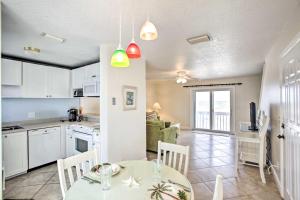 a kitchen and living room with a table and chairs at Bright Fernandina Beach Townhome Walk to Ocean! in Fernandina Beach