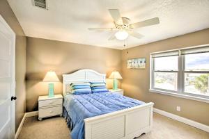 a bedroom with a bed and a ceiling fan at Bright Fernandina Beach Townhome Walk to Ocean! in Fernandina Beach