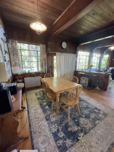 a dining room with a wooden table and chairs at HIGHLAND HOLIDAY LIMIT 7-10 cottage in Bridgton