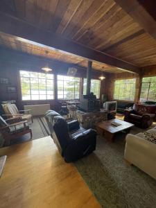 a living room with a couch and a table at HIGHLAND HOLIDAY LIMIT 7-10 cottage in Bridgton