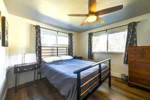 a bedroom with a bed and a ceiling fan at Dog-Friendly Oakhurst Home Walk to Downtown! in Oakhurst
