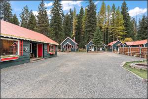a group of houses on a road with trees at Brundage Bungalows in McCall