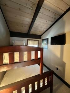 a bedroom with two bunk beds in a room at ALPINE VILLAGE GETAWAY LIMIT 8 cottage in Bridgton