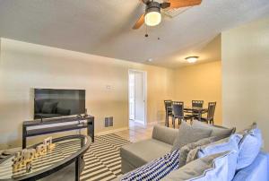a living room with a couch and a flat screen tv at Sunny Indian Rocks Beach Condo Steps to Gulf! in Clearwater Beach