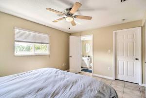 a bedroom with a bed and a ceiling fan at Sunny Indian Rocks Beach Condo Steps to Gulf! in Clearwater Beach
