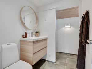 a bathroom with a sink and a mirror at Holiday Home Kadife - 750m from the sea in NW Jutland by Interhome in Saltum