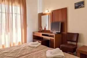 Postel nebo postele na pokoji v ubytování Aeolos Hotel