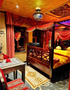 um quarto com uma cama de dossel e uma mesa em B&B Agrabah, 1001 nights em Lomm