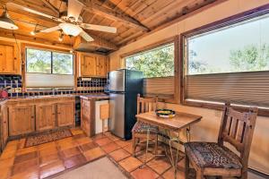 a kitchen with a refrigerator and a table and chairs at Taos Studio with Shared Hot Tub in Historic District in Taos