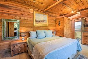 a bedroom with a bed in a log cabin at Taos Studio with Shared Hot Tub in Historic District in Taos