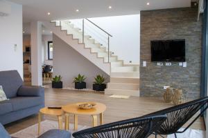 a living room with a couch and a table at Sunrise Villa in Sagres