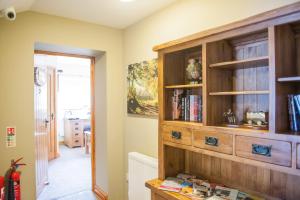 a large wooden book shelf in a room at The Little Crown Inn in Pontypool