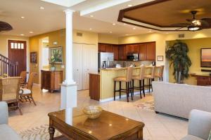 a living room and kitchen with a couch and a table at Mauna Lani Palm Villas H-4 Amazing View Corner Unit in Waikoloa