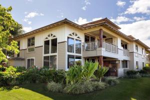 a large house with a balcony and a yard at Mauna Lani Palm Villas H-4 Amazing View Corner Unit in Waikoloa