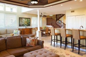 a living room with a couch and a bar at Mauna Lani Palm Villas H-4 Amazing View Corner Unit in Waikoloa