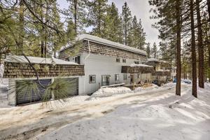 a house in the woods with snow on the ground at Zephyr Cove Vacation Rental 1 Mi to Lake Tahoe! in Zephyr Cove