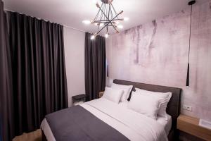 a bedroom with a bed and a chandelier at Emar Apartment - old town center in Zadar