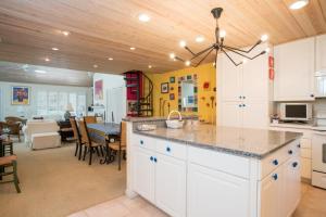 a kitchen with white cabinets and a dining room at Fisherman's Recess in Ponte Vedra Beach