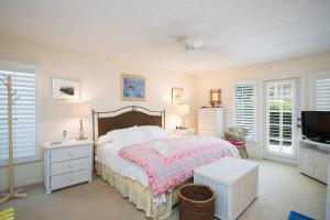 a bedroom with a bed and a flat screen tv at Fisherman's Recess in Ponte Vedra Beach