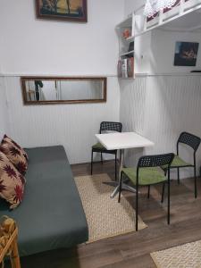 a room with a bed and two chairs and a table at Dorćoleta in Belgrade