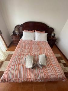 um quarto com uma cama com duas almofadas em Blue Tex em Vila Chã