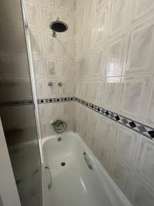 a white tub in a bathroom with a shower at Blue Tex in Vila Chã