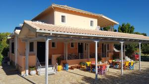 a house with a pavilion with a table and chairs at Evaggelia Studios in Lefkada Town