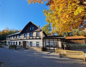 un gran edificio con un banco delante en Hotel Waldquelle - Baumhaushotel Aerzen, en Aerzen