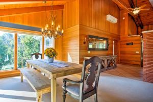 a dining room with a wooden table and chairs at 7-Acre Coastal Michigan Home with Hot Tub and Sauna! in Ludington