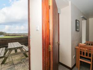 an open door to a balcony with a table at The Linhay in Bridport +16 photos