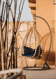 a bird cage sitting next to a wall at Tulum Beach Resort Dakhla in Dakhla