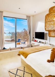 a bedroom with a large bed and a large window at Tulum Beach Resort Dakhla in Dakhla