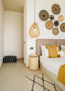a bedroom with a bed and a pendant light at Tulum Beach Resort Dakhla in Dakhla