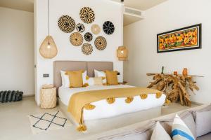 a bedroom with a large bed and a couch at Tulum Beach Resort Dakhla in Dakhla